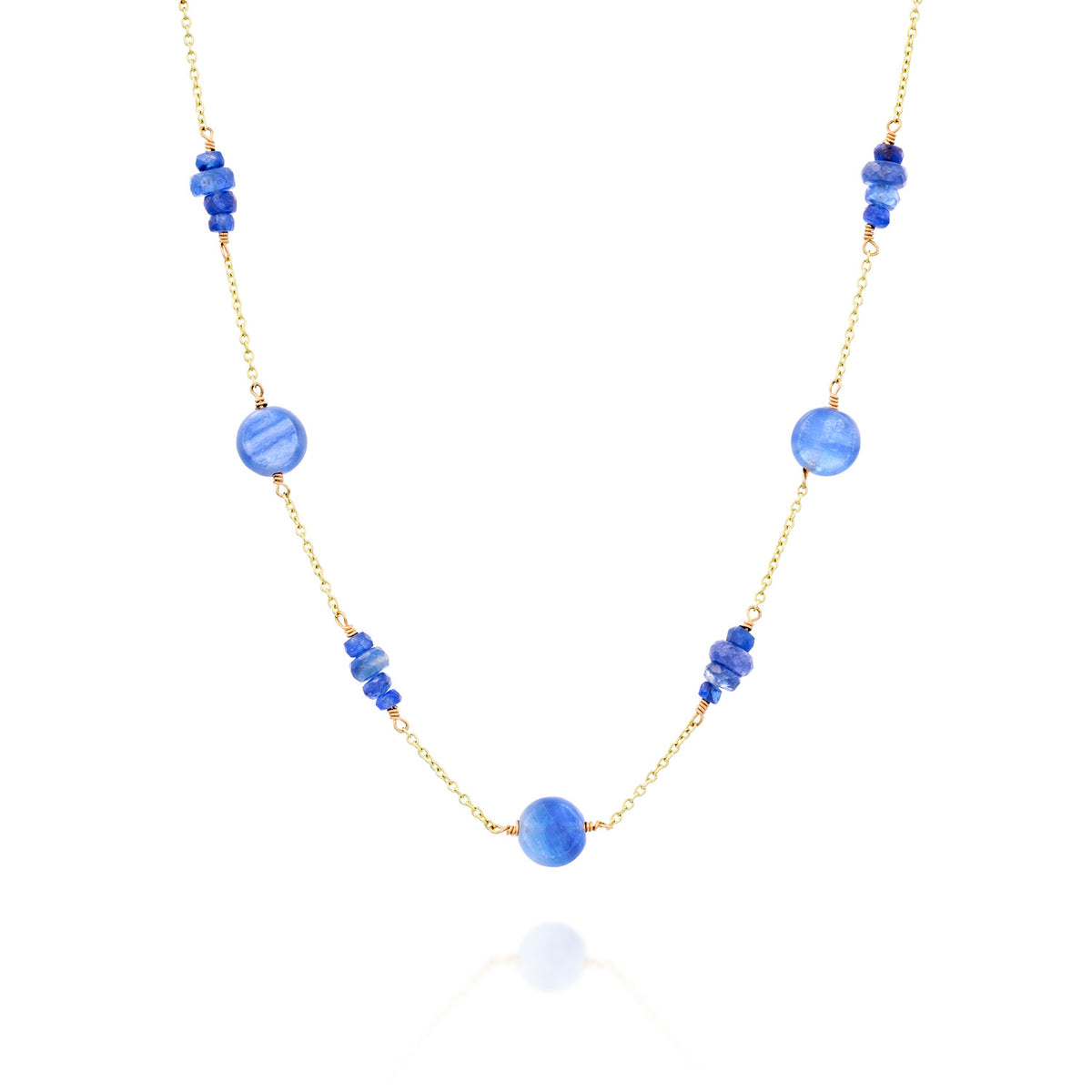 Lagoon necklace in 14K yellow gold with flat round light blue kyanite stones and clusters of four deep blue sapphires